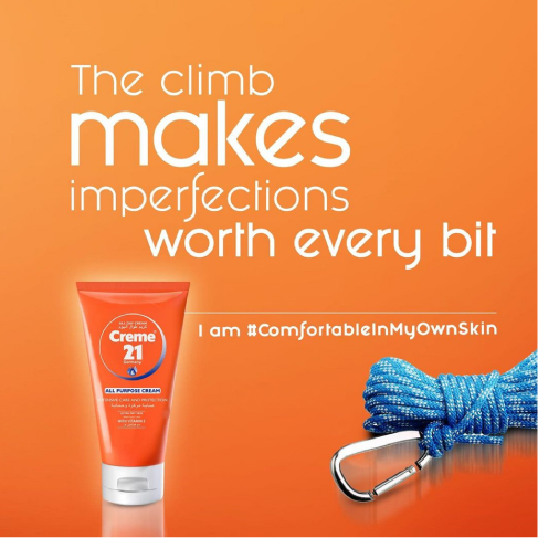 Creme 21 skincare advertisement with climbing rope and text "The climb makes imperfections worth every bit".