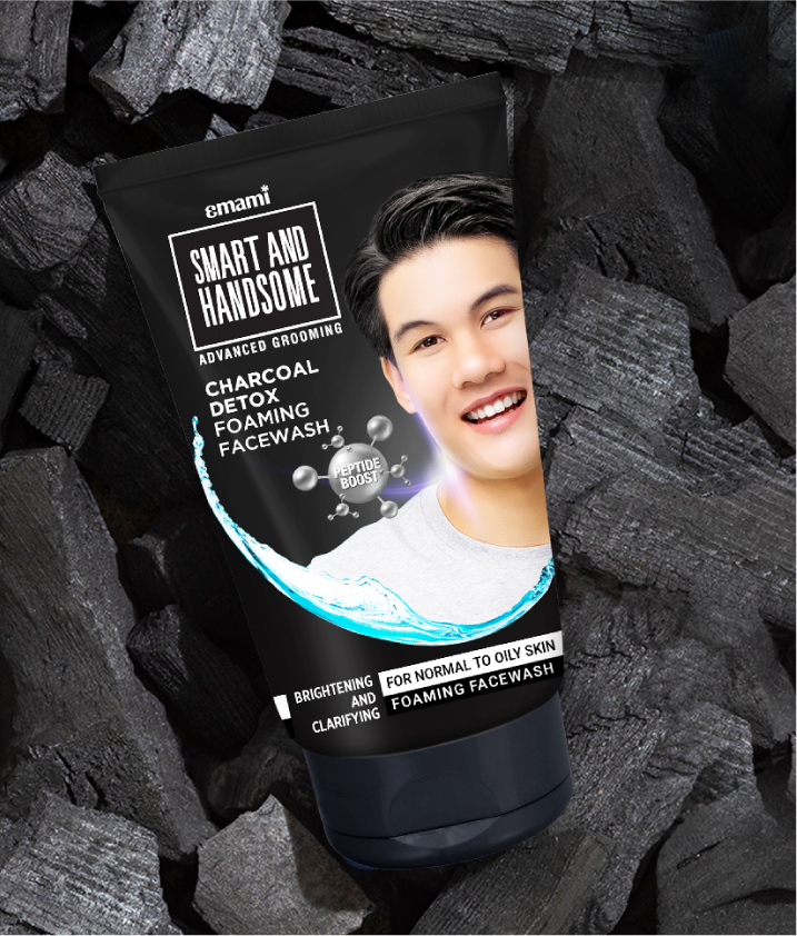 Black tube of Emami Smart and Handsome Charcoal Detox Foaming Facewash for normal to oily skin on charcoal background.