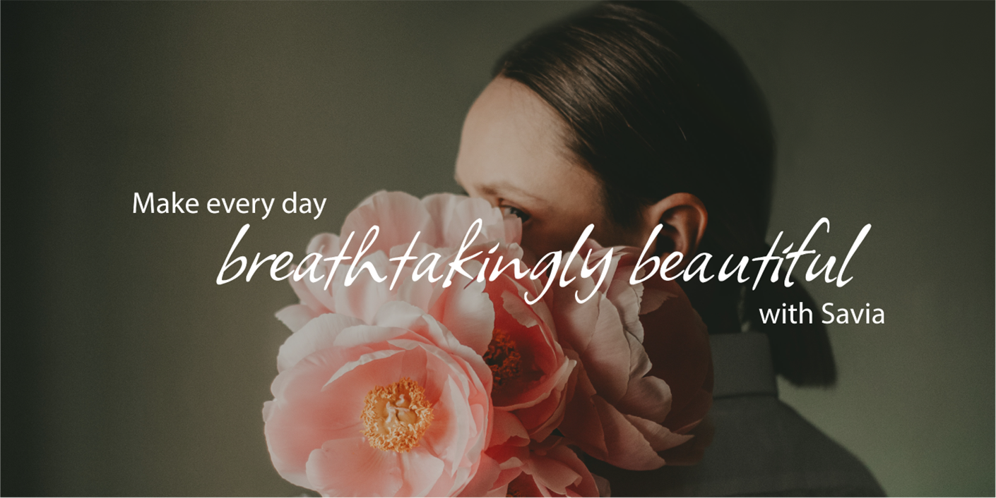 Savia brand ad with woman holding pink flowers and text "Make every day breathtakingly beautiful with Savia".