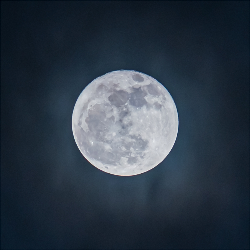 A detailed full moon against a dark night sky, showing craters and surface texture clearly.