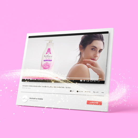 YouTube ad for Enchanteur Perfumed Body Lotion with a pink and white floral bottle and a woman applying lotion to her shoulder.