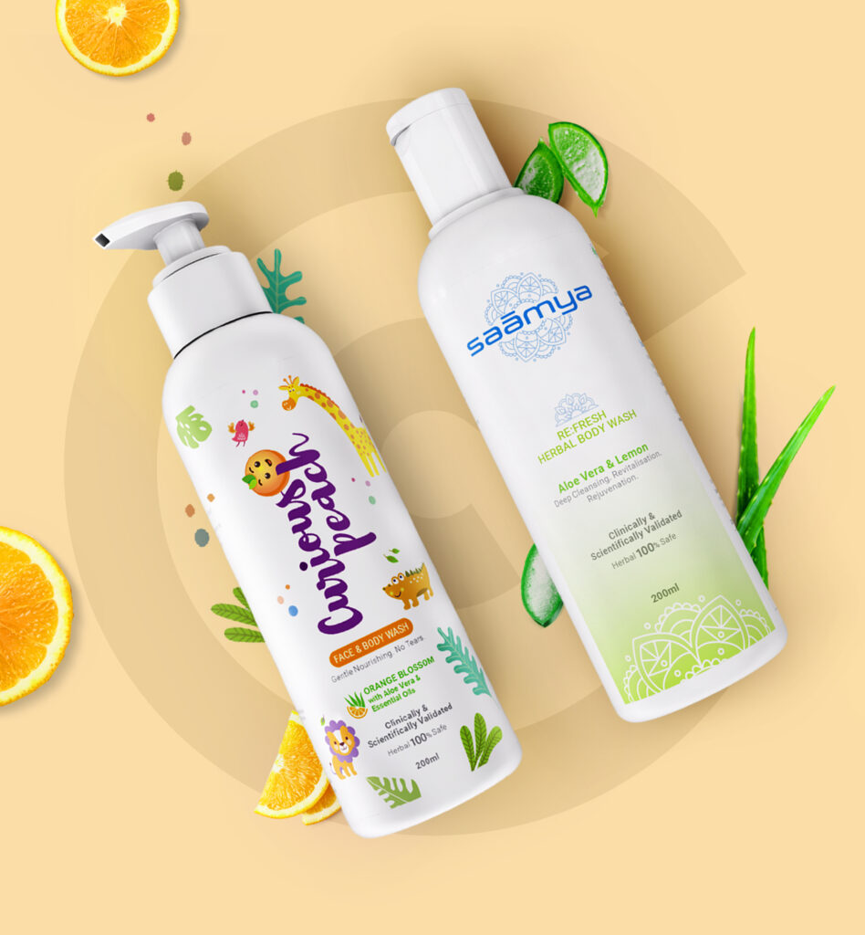 Two white body wash bottles with orange slices, lime wedges, and green leaves on warm yellow background