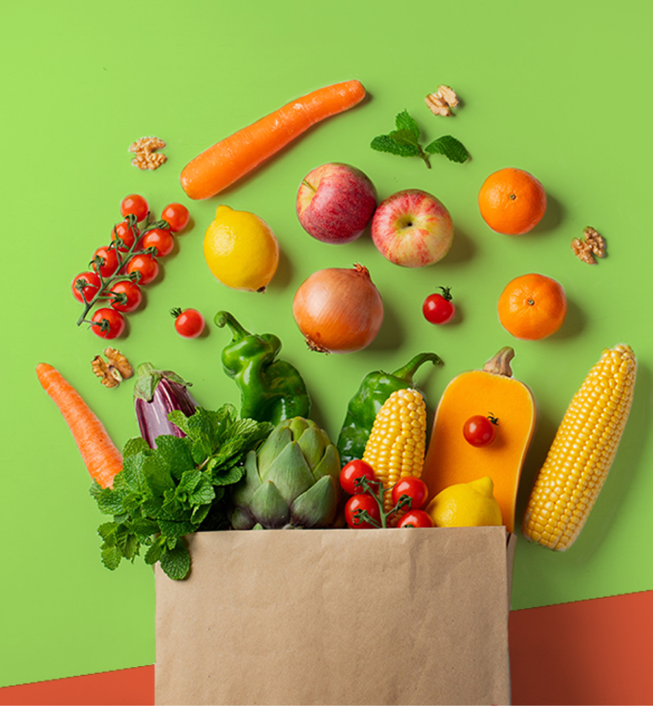 A brown paper bag overflowing with fresh fruits, vegetables, nuts, and herbs on a vibrant green background.