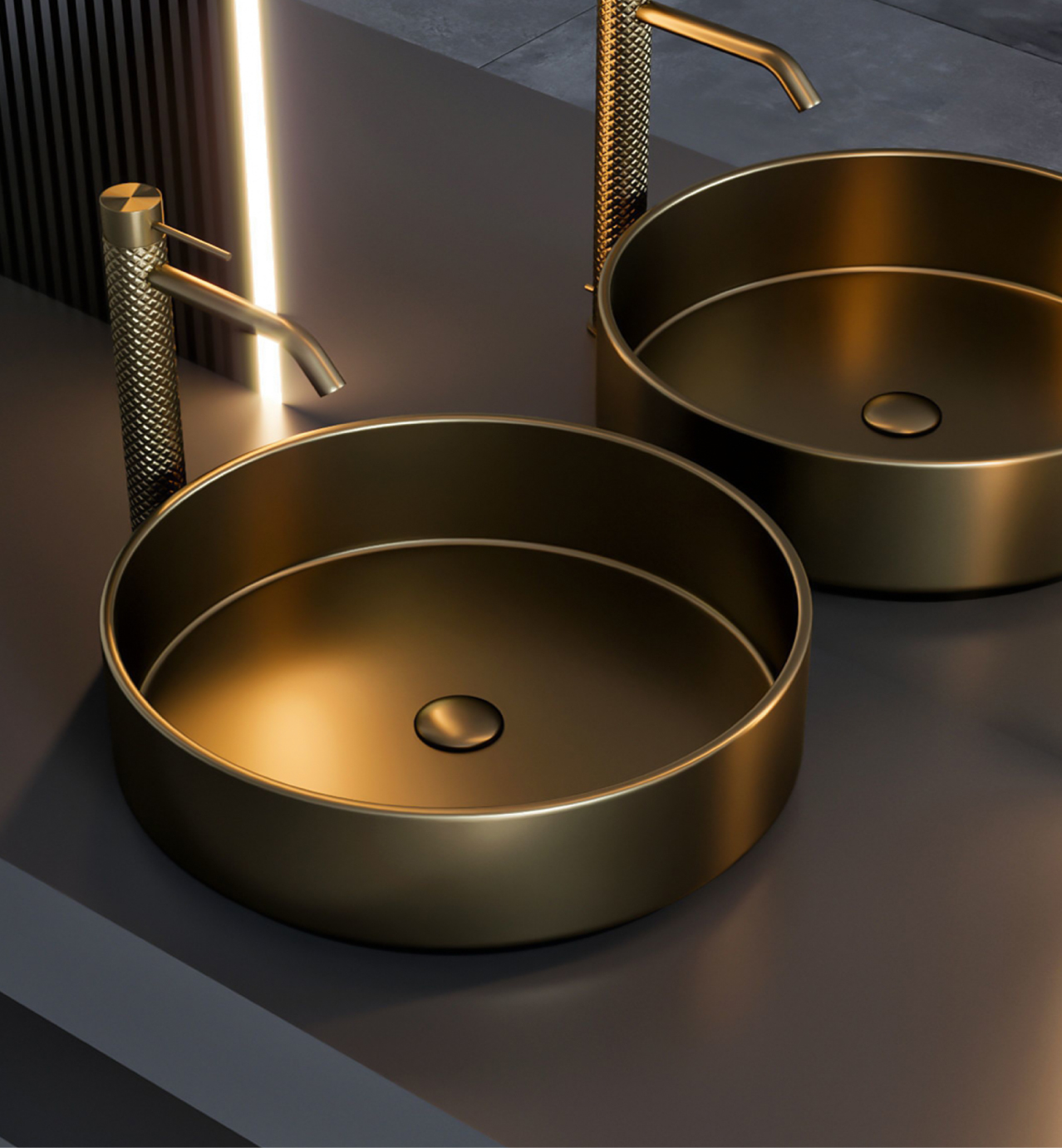 Modern bathroom with two round gold sinks and matching gold faucets on a sleek gray countertop.