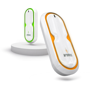 Two sleek Aromos devices with green and orange accents displayed on white round platforms against a white background.
