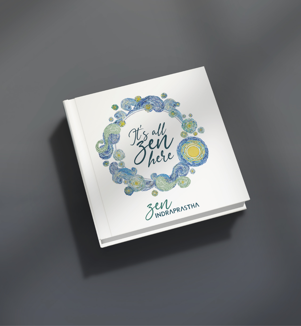Square book with "It's all zen here" and "zen INDRAPRASTHA" on the cover, surrounded by a decorative blue and yellow wreath.