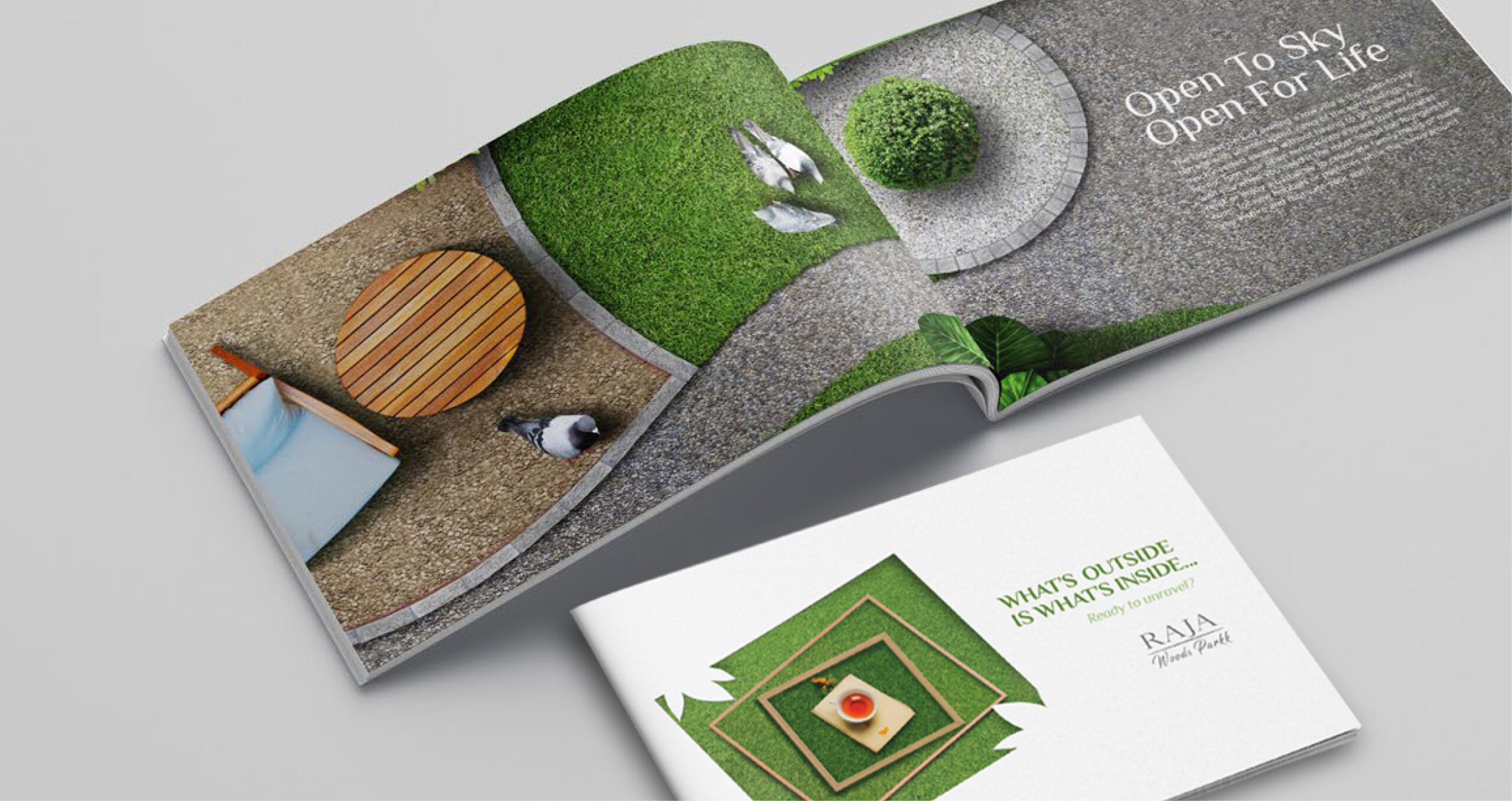 An open brochure with garden visuals and text, next to a cover reading "WHAT'S OUTSIDE IS WHAT'S INSIDE… RAJA Woods Park."