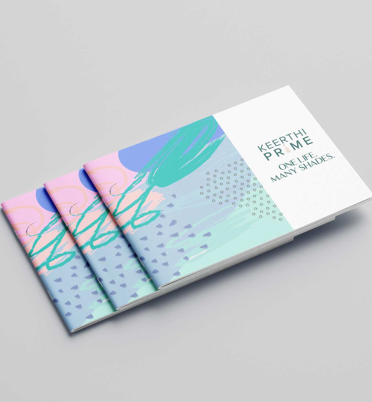 Three colorful booklets with abstract designs and the text "Keerthi Prime. One Life. Many Shades." on the cover.