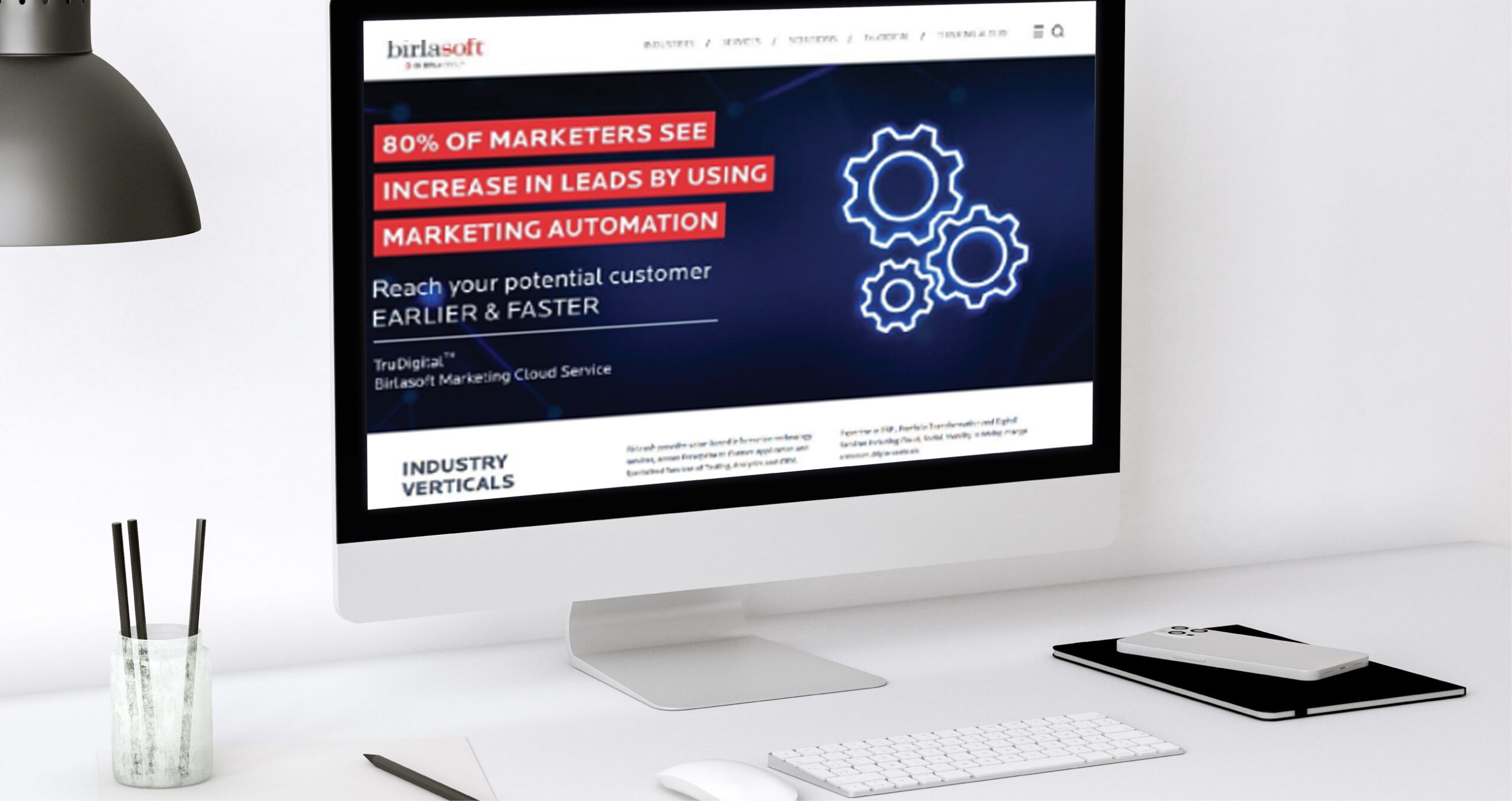 Birlasoft website on a desktop screen highlighting increased leads with marketing automation and blue neon gear icons.