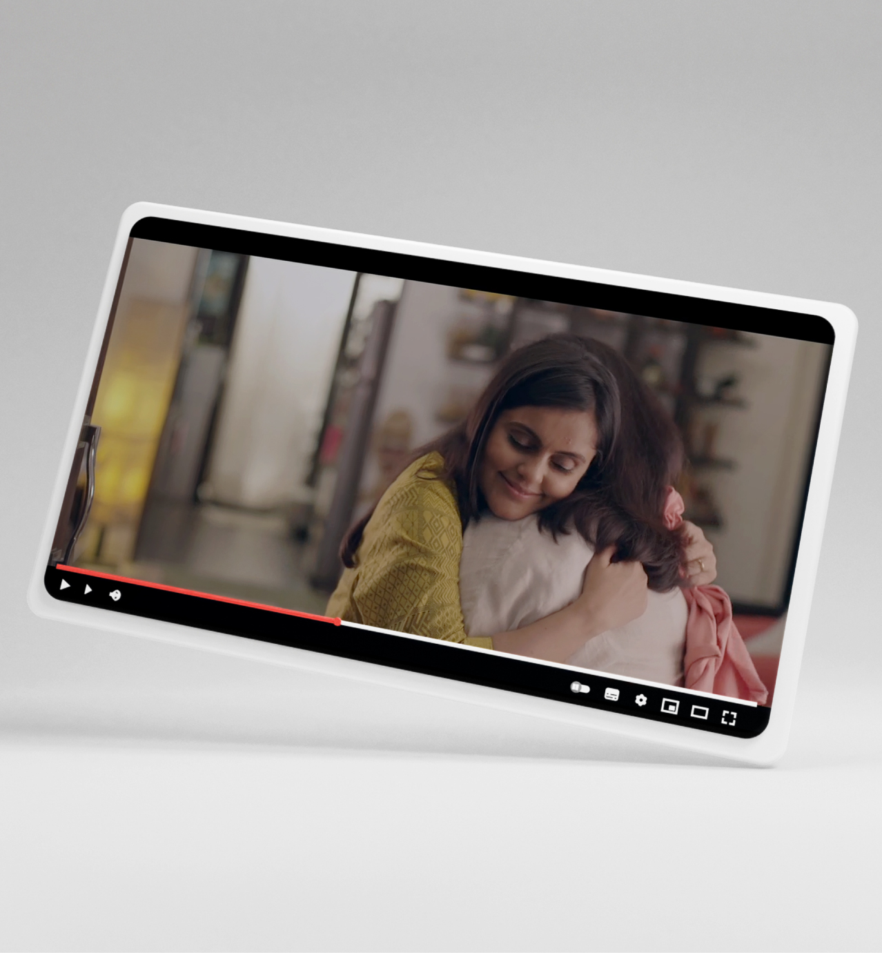 Video player mockup displaying mother and child embracing in warm lighting with playback controls visible.