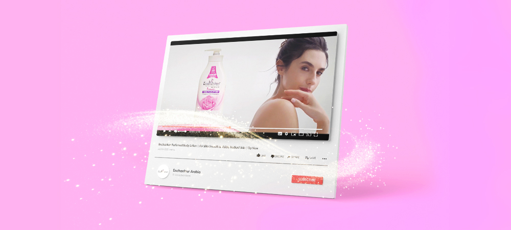 YouTube ad for Enchanteur Perfumed Body Lotion shows a woman applying lotion to her shoulder, with sparkles on a pink background.