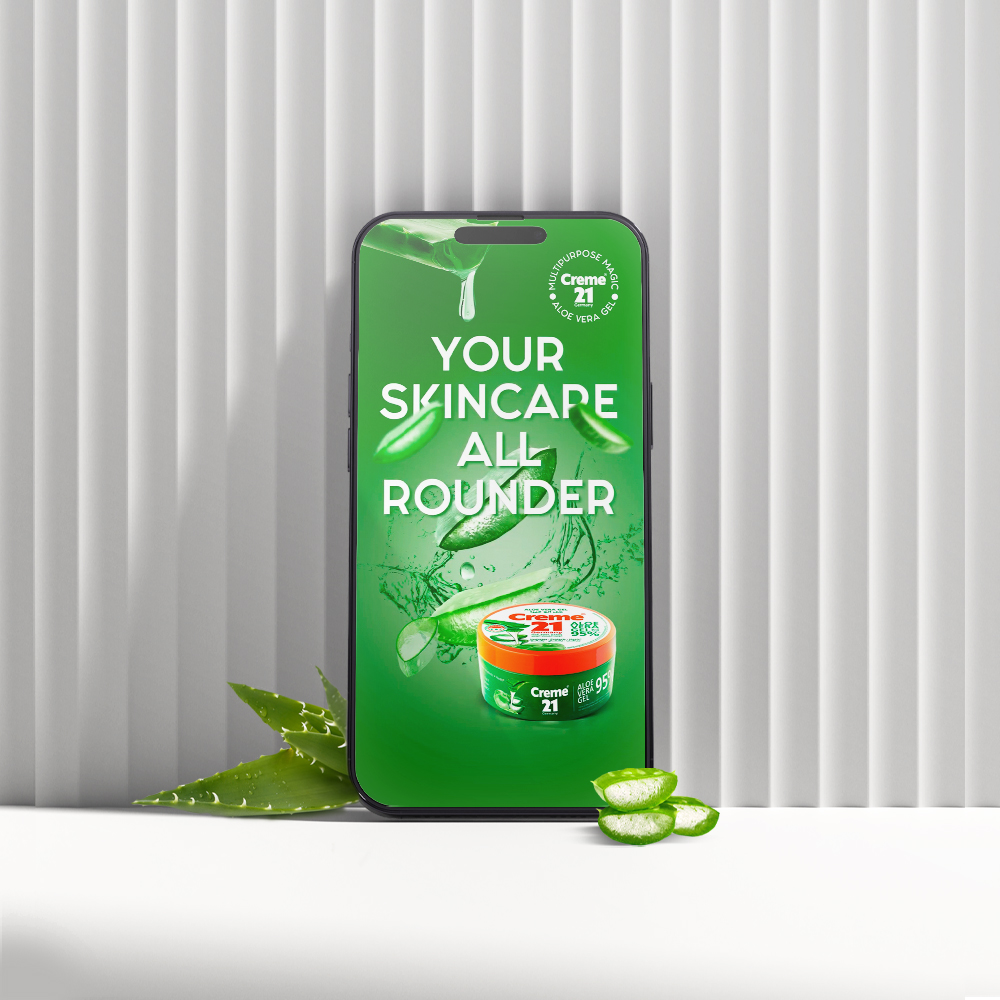 A phone displays a Creme 21 skincare ad with aloe vera images and text: "Your Skincare All Rounder" on a green background.