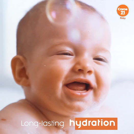 Baby with water on head, promoting Creme 21 Baby and the phrase "Long-lasting hydration" in the lower corner.