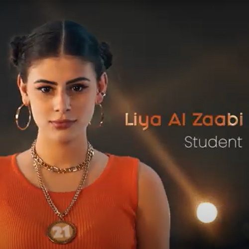 A student with braided hair in an orange top and '21' pendant, name Liya Al Zaabi shown onscreen.