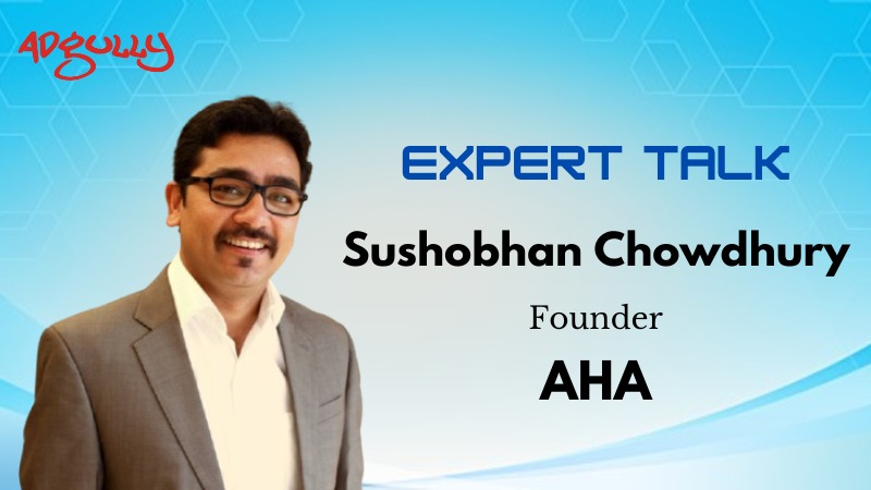 Man in suit on blue tech background with text: "EXPERT TALK Sushobhan Chowdhury Founder AHA" and "Adgully" logo.