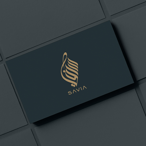 A dark business card features a gold abstract logo above the word SAVIA on a geometric background.