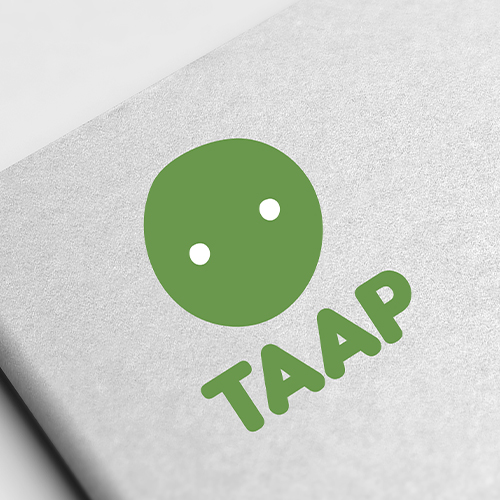 Green circle with two white dots above the word "TAAP" in bold green letters on a grey surface.
