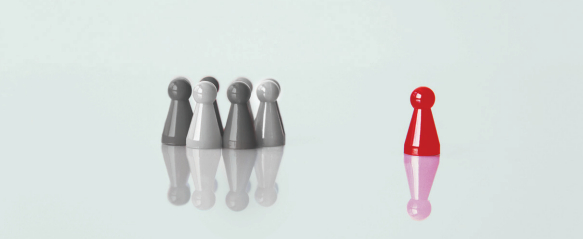 Red pawn standing apart from grey pawns